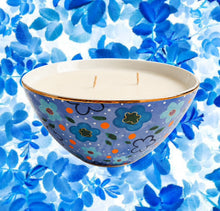 Load image into Gallery viewer, Decorative candle in a floral-patterned bowl on a blue floral background
